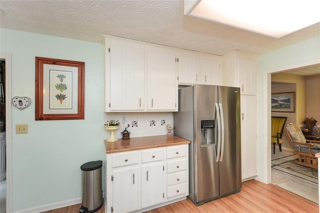 2261 Ravenwood Trl, Marietta, GA 30066 - kitchen featuring stainless steel fridge with ice dispenser, white cabinets, light wood-type flooring, and tasteful backsplash