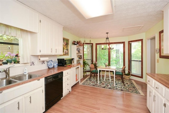 2261 Ravenwood Trl, Marietta, GA 30066 - kitchen with black dishwasher, stainless steel microwave, a sink, a textured ceiling, and white cabinetry