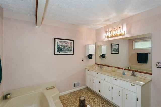 2261 Ravenwood Trl, Marietta, GA 30066 - bathroom featuring double vanity, a garden tub, a textured ceiling, and baseboards