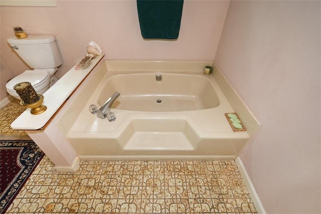 2261 Ravenwood Trl, Marietta, GA 30066 - bathroom featuring a bath, baseboards, and toilet