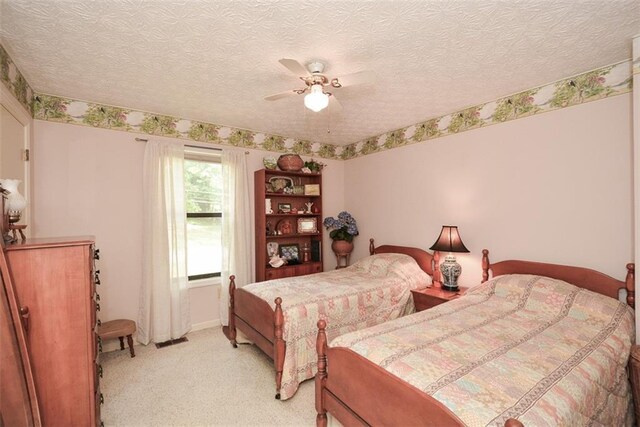 2261 Ravenwood Trl, Marietta, GA 30066 - bedroom featuring light carpet, a textured ceiling, and a ceiling fan