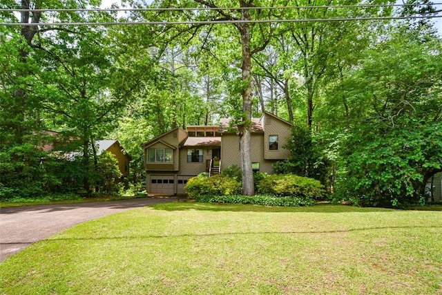 2261 Ravenwood Trl, Marietta, GA 30066 - mid-century inspired home with driveway, an attached garage, a front yard, and view of scattered trees
