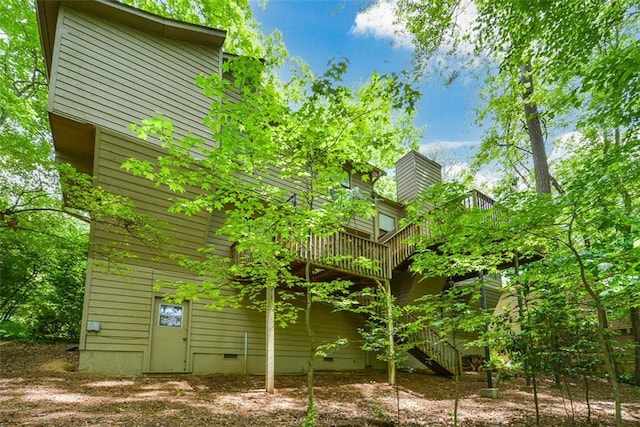 2261 Ravenwood Trl, Marietta, GA 30066 - view of side of property with crawl space, a deck, stairs, and a chimney