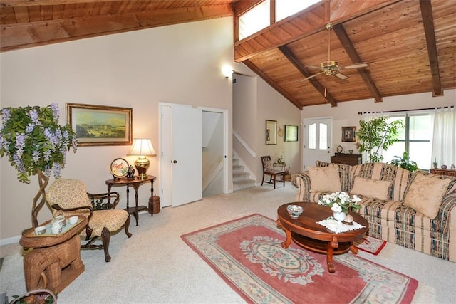2261 Ravenwood Trl, Marietta, GA 30066 - carpeted living area featuring wooden ceiling with exposed beams, stairs, ceiling fan, and high vaulted ceiling