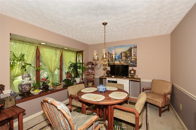 2261 Ravenwood Trl, Marietta, GA 30066 - dining area featuring a chandelier, light carpet, baseboards, and a textured ceiling