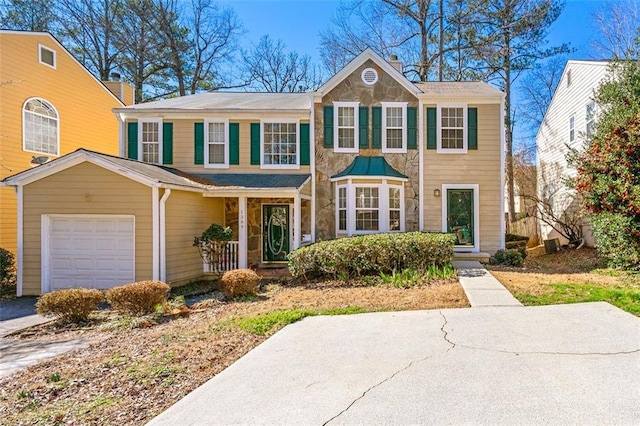 view of front of house featuring a garage, driveway, and a chimney