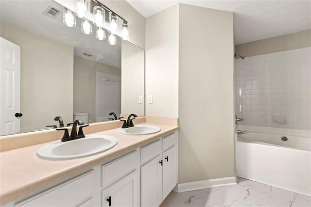 bathroom with marble finish floor, baseboards, visible vents, and a sink