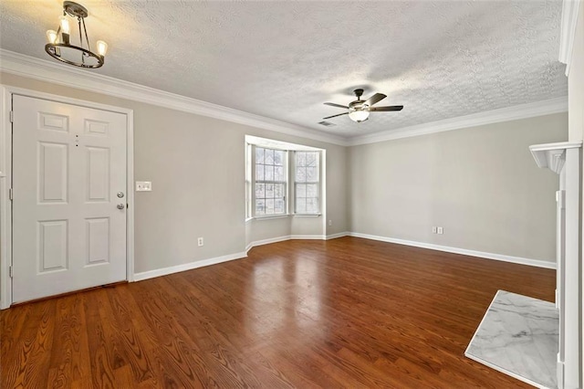 foyer featuring a textured ceiling, ceiling fan with notable chandelier, wood finished floors, baseboards, and ornamental molding