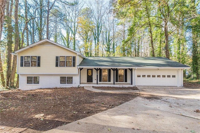 tri-level home with a porch and a garage