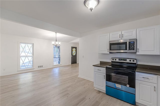 kitchen with stainless steel appliances, pendant lighting, a notable chandelier, white cabinets, and light hardwood / wood-style floors