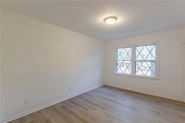 empty room with light hardwood / wood-style flooring