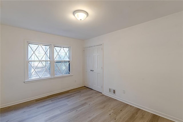 spare room with light hardwood / wood-style flooring