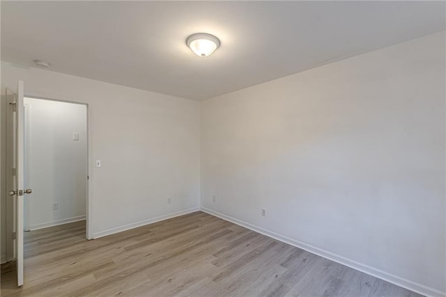 spare room with light hardwood / wood-style flooring