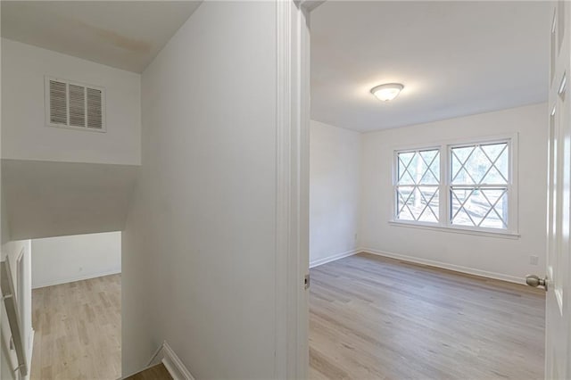 hall with light hardwood / wood-style floors