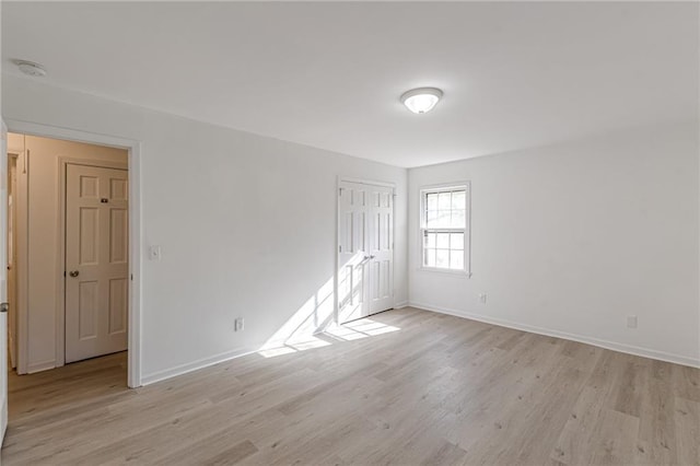 unfurnished room with light hardwood / wood-style floors