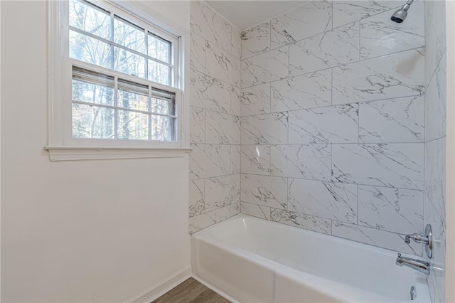 bathroom featuring hardwood / wood-style floors and tiled shower / bath