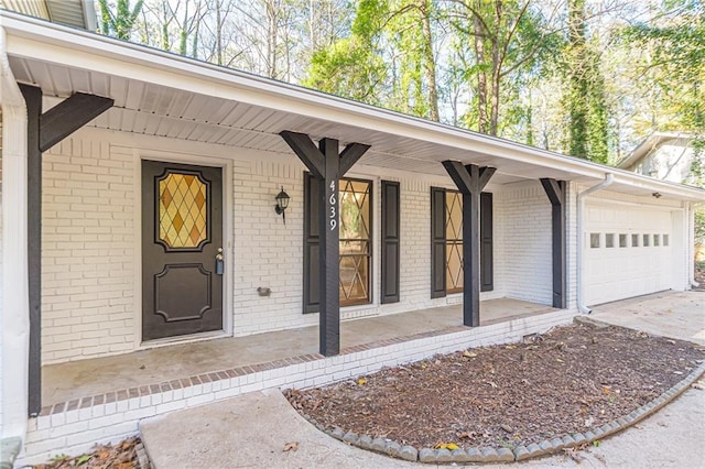 entrance to property with a porch and a garage