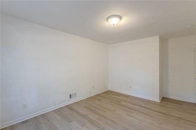 spare room featuring light wood-type flooring