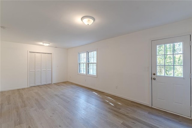 interior space with a wealth of natural light and light hardwood / wood-style floors