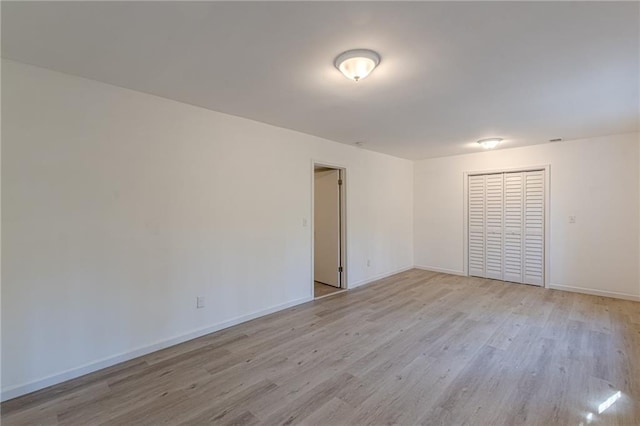 spare room featuring light hardwood / wood-style floors