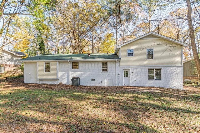 back of property featuring a lawn and central AC unit