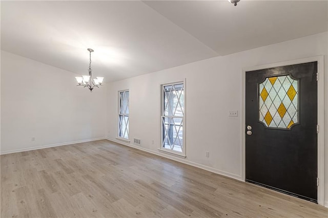 foyer featuring a chandelier and light hardwood / wood-style floors