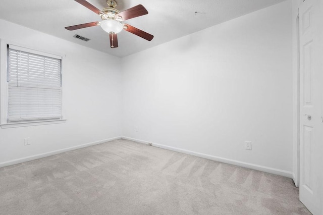 spare room with light colored carpet and ceiling fan