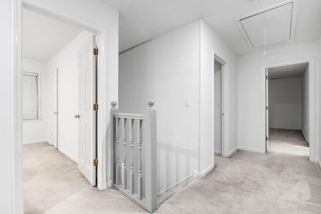 hallway featuring light colored carpet