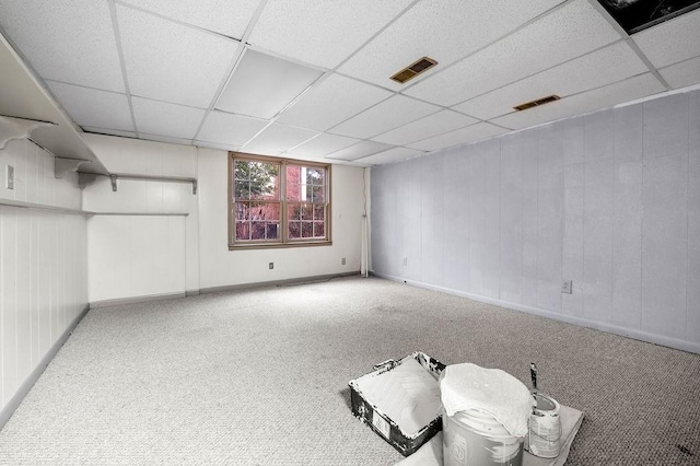 basement with carpet floors and a drop ceiling