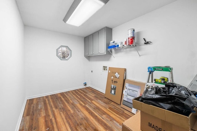 laundry area with hookup for a washing machine, cabinets, hardwood / wood-style flooring, and hookup for an electric dryer