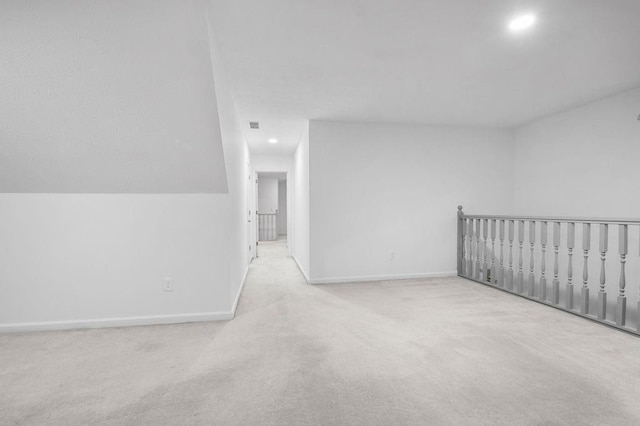 bonus room with light colored carpet