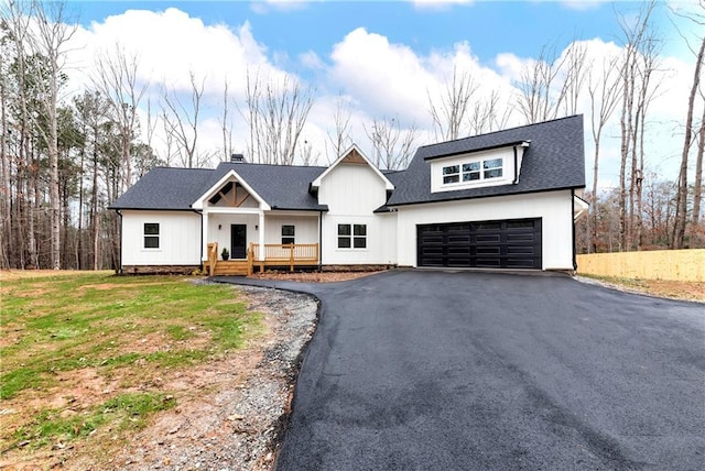 2710 Castleberry Bridge Rd, Dawsonville, GA 30534 - modern inspired farmhouse with covered porch, aphalt driveway, a shingled roof, and a garage