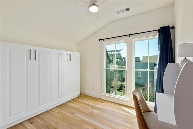 unfurnished room with lofted ceiling and light hardwood / wood-style flooring