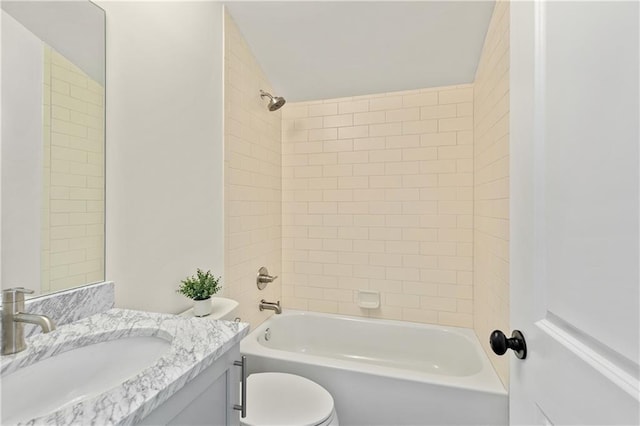 full bathroom featuring toilet, tiled shower / bath, and vanity