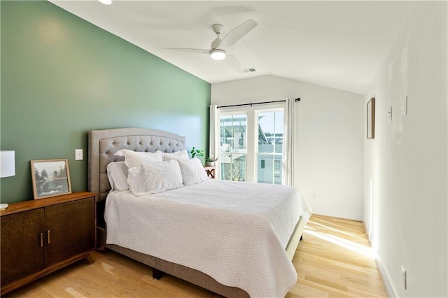 bedroom featuring ceiling fan, light hardwood / wood-style floors, and lofted ceiling