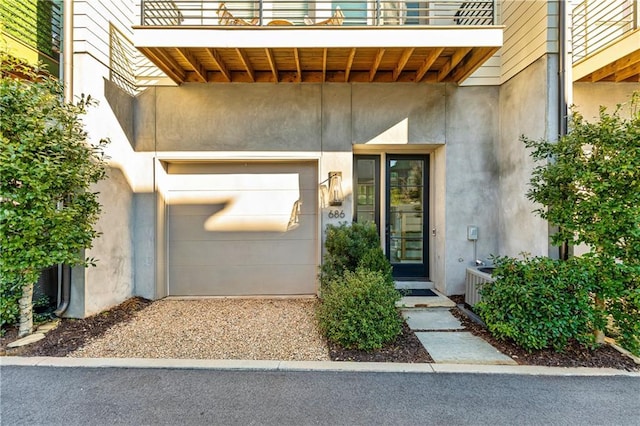 property entrance featuring a balcony and a garage