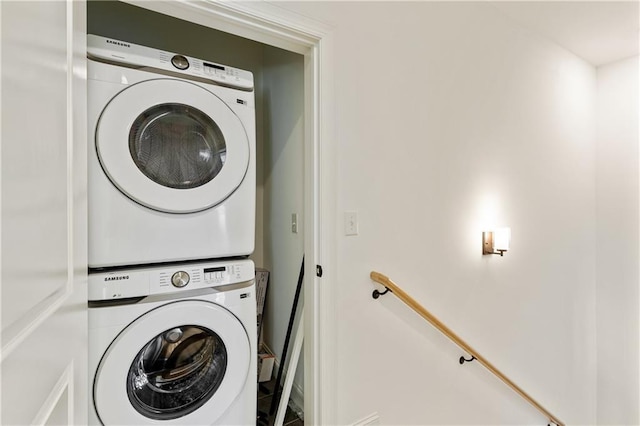 washroom featuring stacked washing maching and dryer