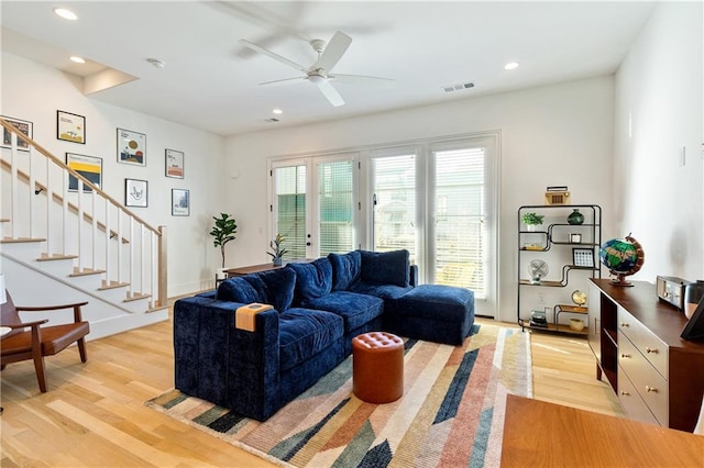 living room with ceiling fan and light wood-type flooring