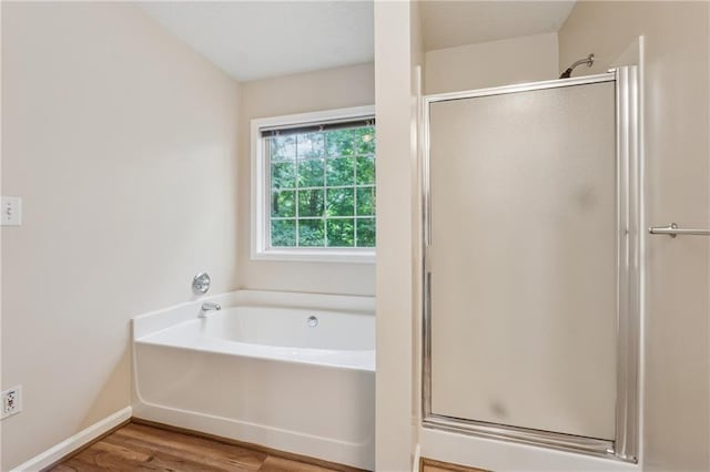 4958 Alpine Ct, Winston, GA 30187 - bathroom featuring a shower stall, a garden tub, wood finished floors, and baseboards