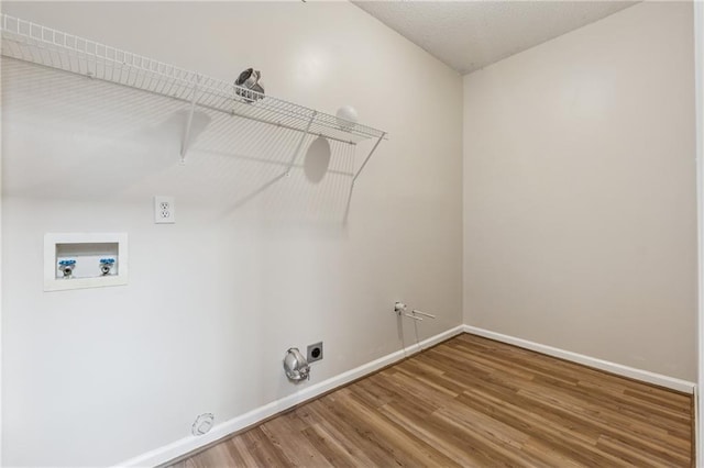 4958 Alpine Ct, Winston, GA 30187 - washroom featuring gas dryer hookup, hookup for a washing machine, wood finished floors, baseboards, and hookup for an electric dryer