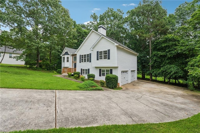 4958 Alpine Ct, Winston, GA 30187 - view of side of home featuring a chimney, driveway, an attached garage, a yard, and view of wooded area