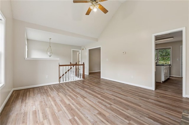 4958 Alpine Ct, Winston, GA 30187 - empty room with ceiling fan, wood finished floors, baseboards, and high vaulted ceiling