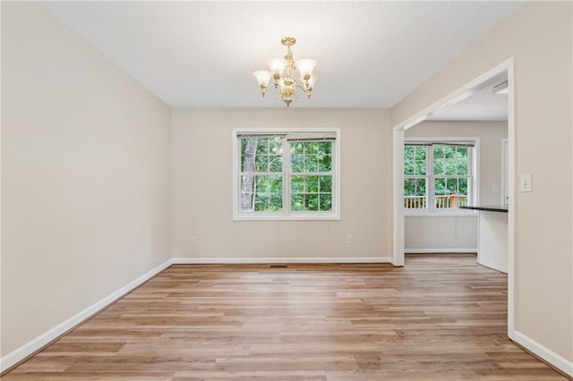 4958 Alpine Ct, Winston, GA 30187 - unfurnished room featuring a chandelier, plenty of natural light, light wood-type flooring, and baseboards