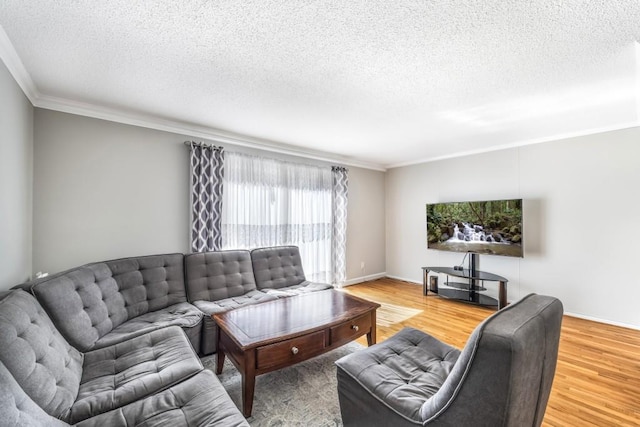 living area featuring crown molding, a textured ceiling, baseboards, and wood finished floors