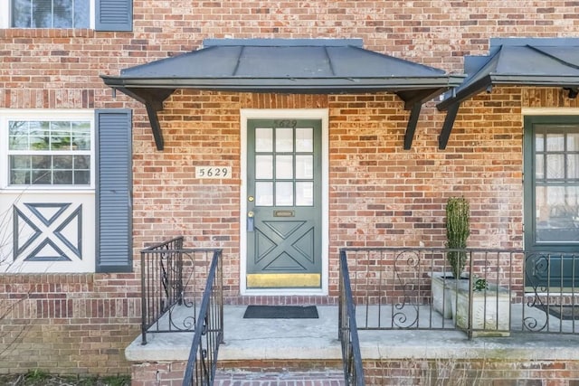 property entrance featuring brick siding