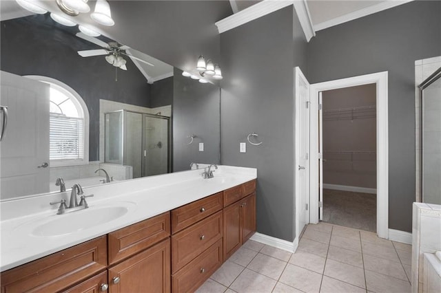 full bath with ceiling fan, a sink, a shower stall, and tile patterned floors