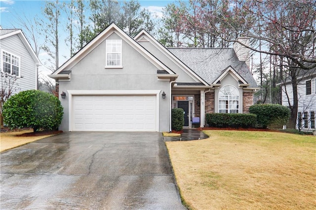 traditional home featuring stucco siding, roof with shingles, driveway, a front yard, and a garage