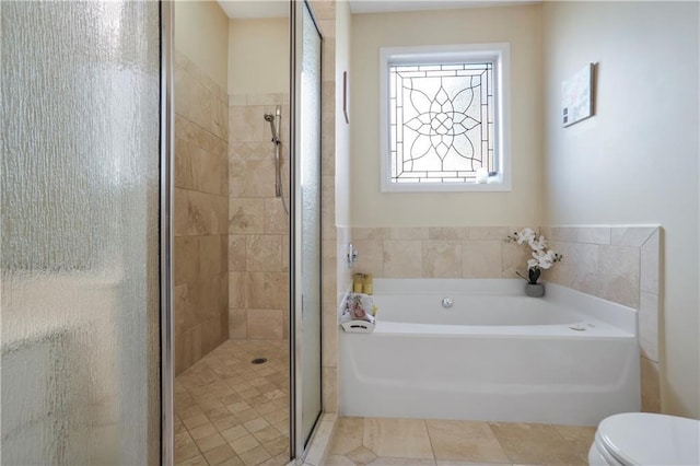 bathroom with a stall shower, double vanity, and a sink
