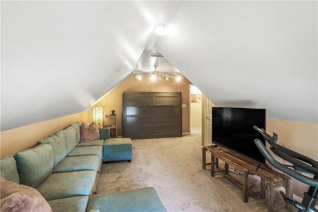 living area featuring lofted ceiling and light colored carpet