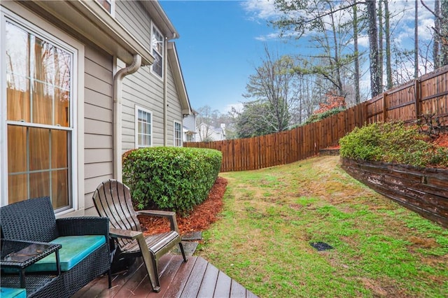 view of yard featuring a fenced backyard and a deck